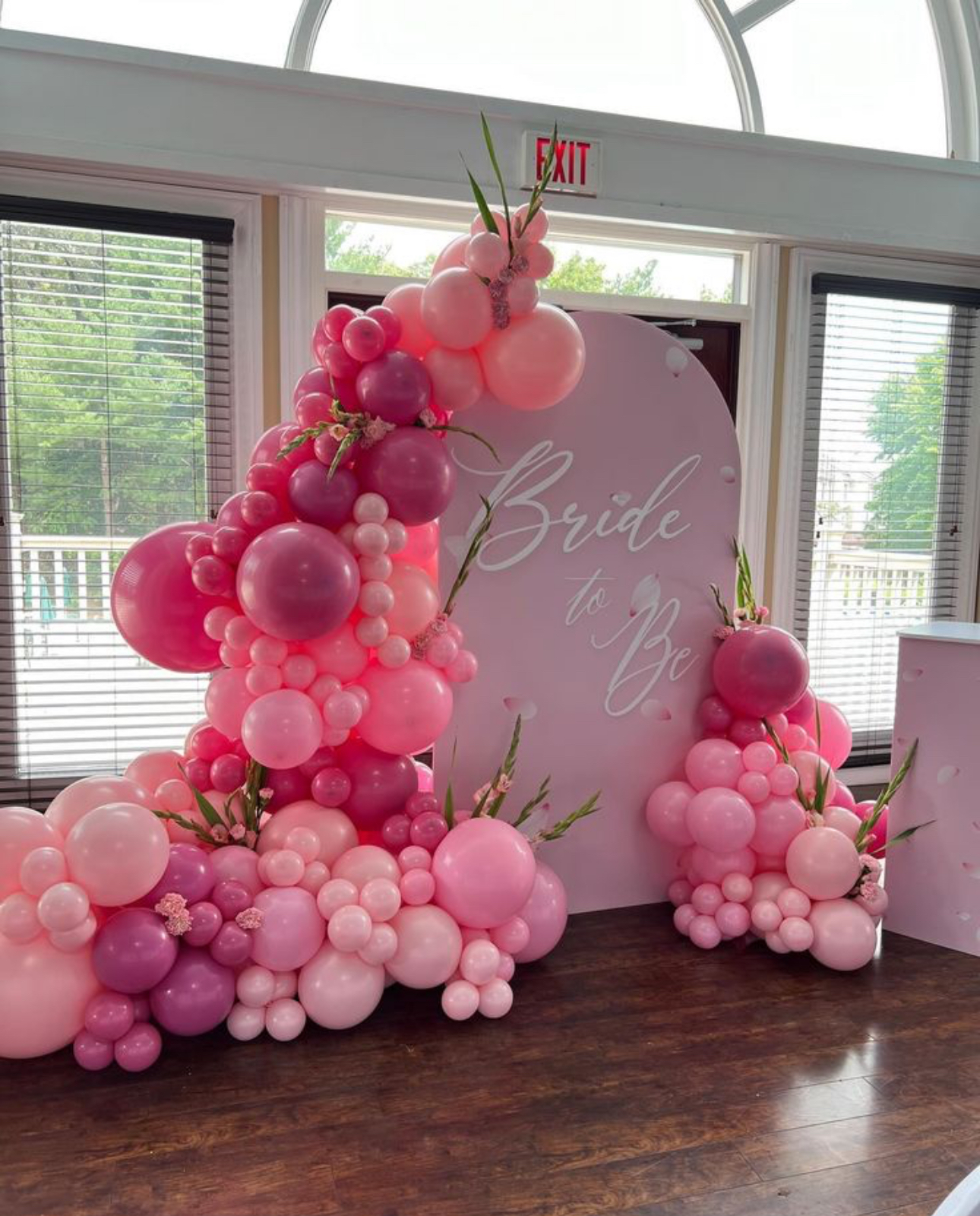 Pink Bride to Be balloon installation with arched backdrop